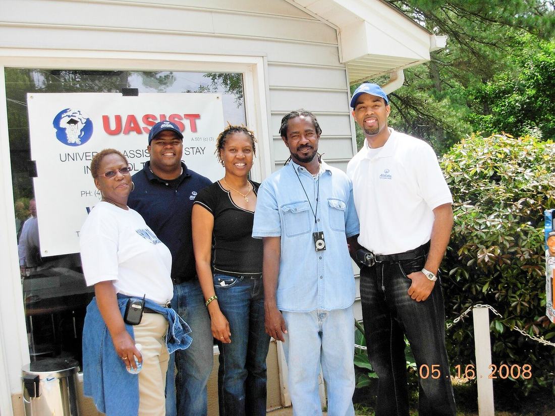 UASIST team members gathered near an organization banner at a community event