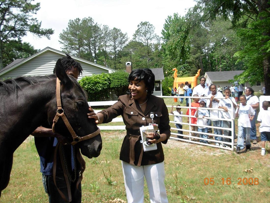 A child meeting a horse during a UASIST field trip